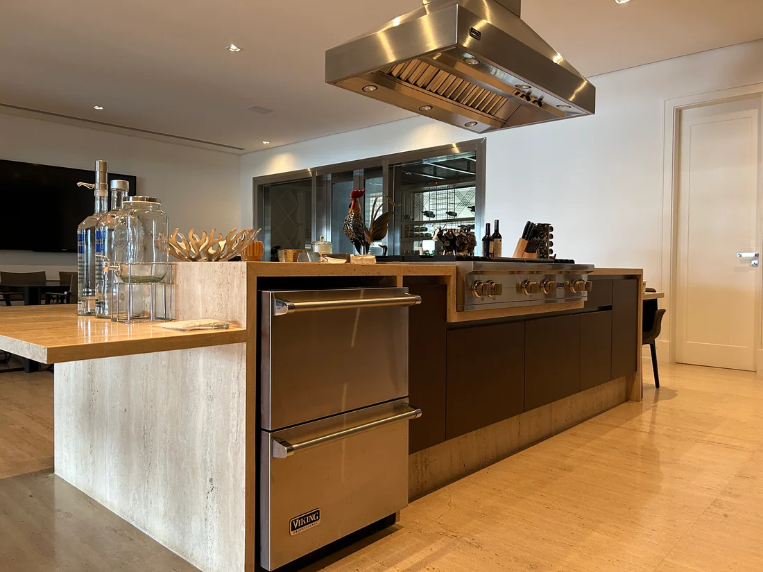 Cozinha residencial premium com cooktop Viking, coifa em inox e gavetas refrigeradas